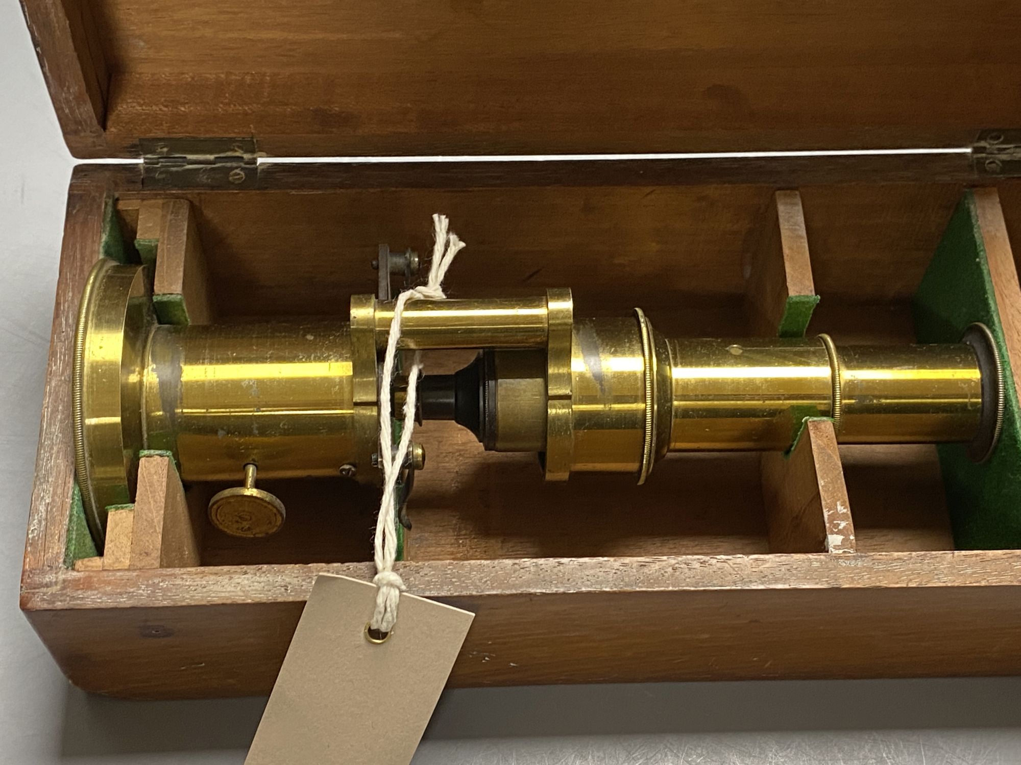 A hinge and wedge compound microscope by Parkes & Son, Birmingham and a lacquered brass students microscope, H 27cm (max); H 21cm